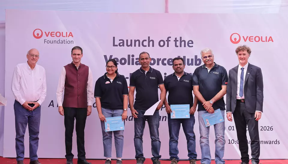Certificate presentation to Veoliaforce volunteers on stage in front of the hub inauguration backdrop